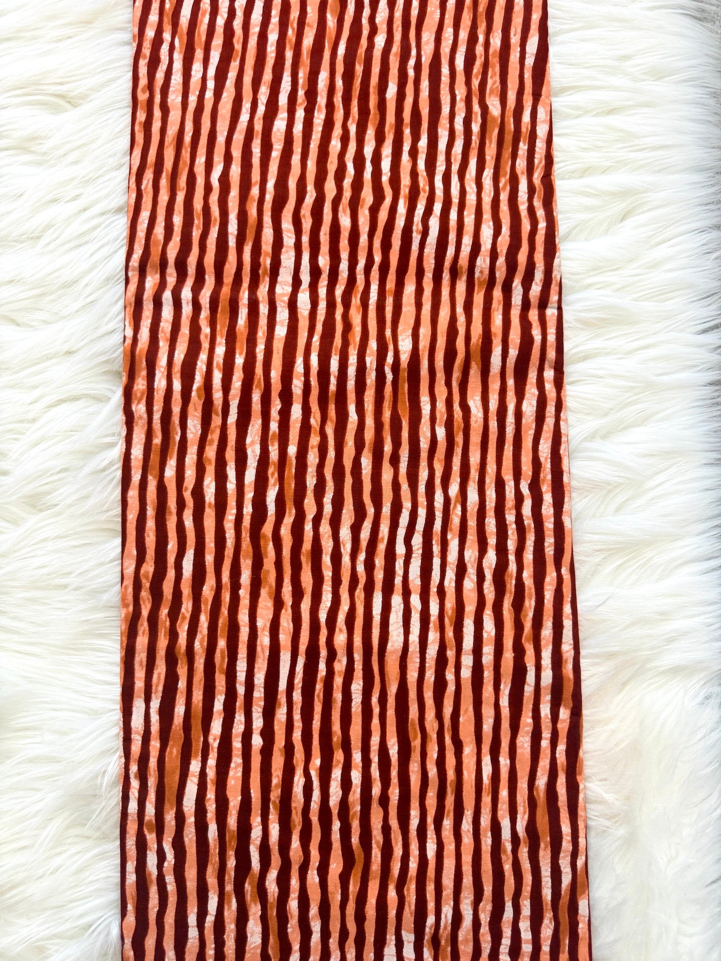 Textured brown and white patterned fabric on a white background