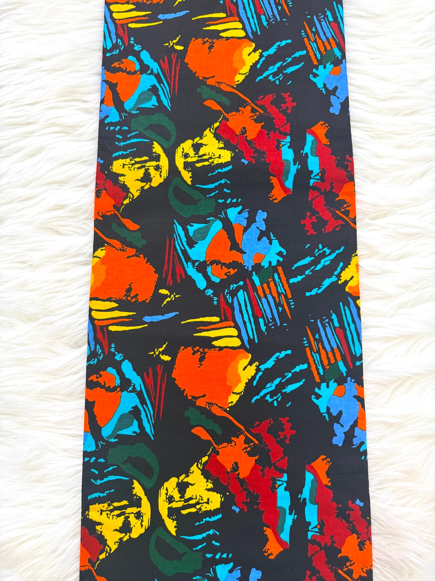 Colorful tie with abstract pattern on a white textured background