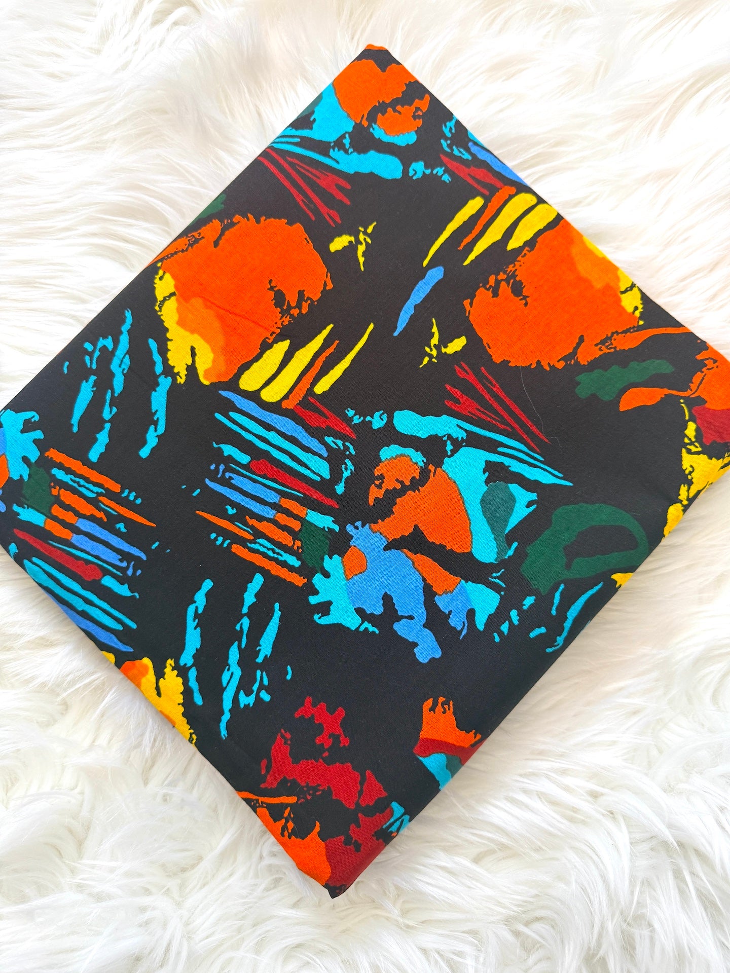 Colorful abstract patterned fabric on a white fluffy surface