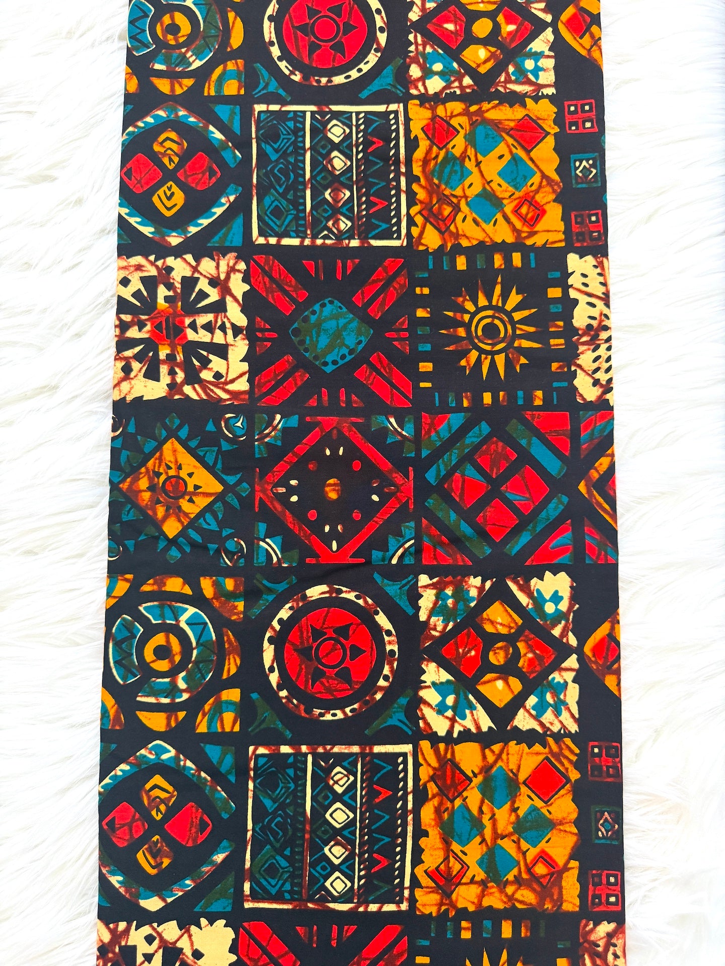Colorful patterned fabric with geometric designs on a white background