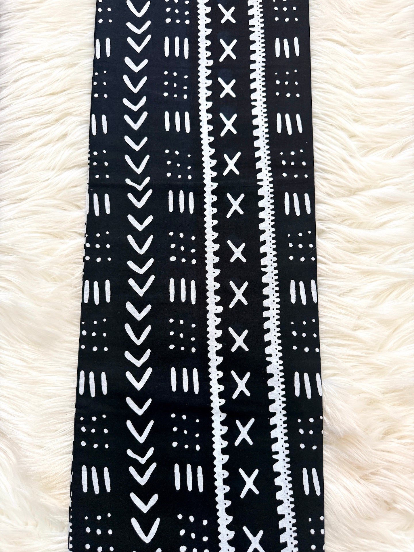 Black and white patterned fabric strip on a white fluffy background