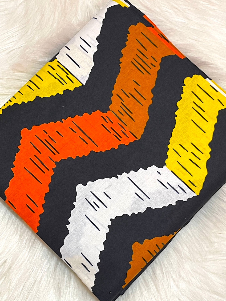 Colorful zigzag patterned fabric on a white background