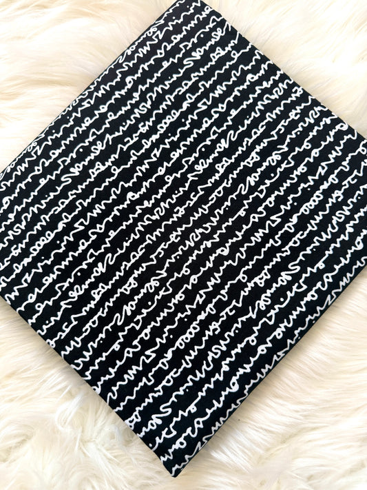 Black and white patterned fabric on a fluffy white surface