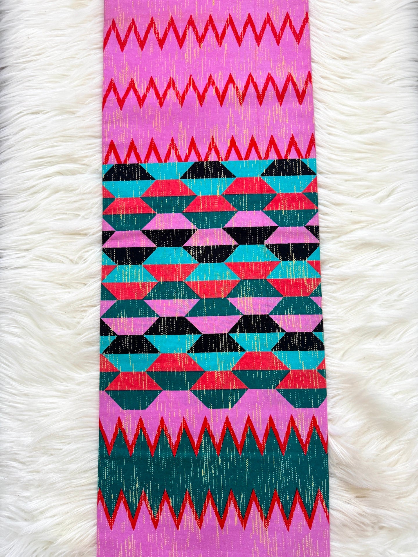 Colorful geometric patterned object on a white textured background