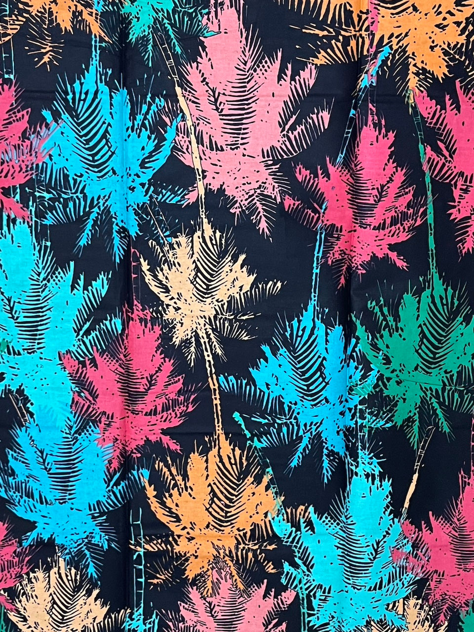 Colorful palm leaf pattern on a black background