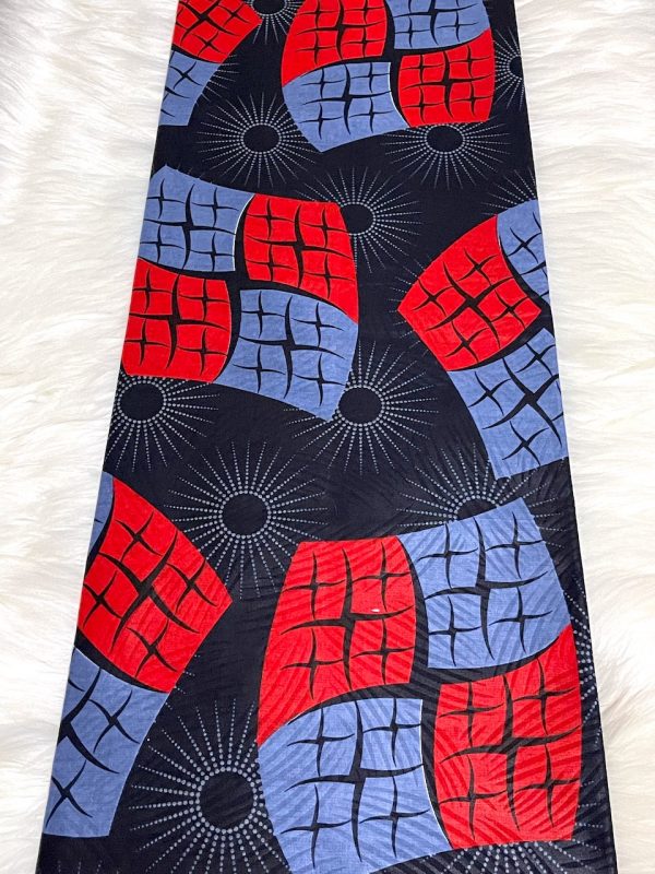 African print fabric with red and blue geometric pattern on a white background