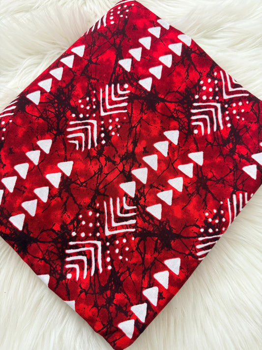 Red fabric with white geometric patterns on a white background