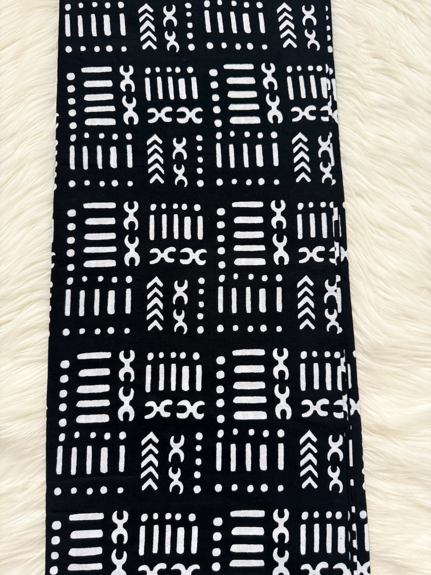 Black fabric with white geometric pattern on a white background