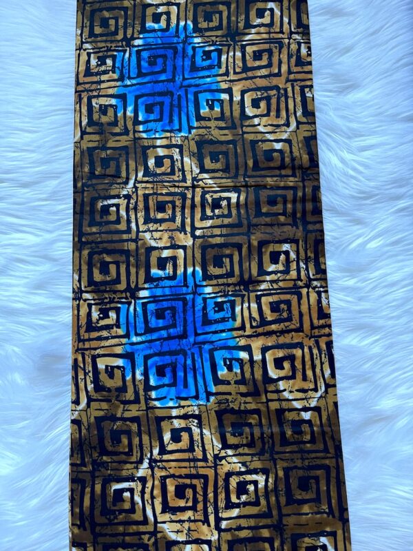 Patterned fabric with blue stain on a textured white background