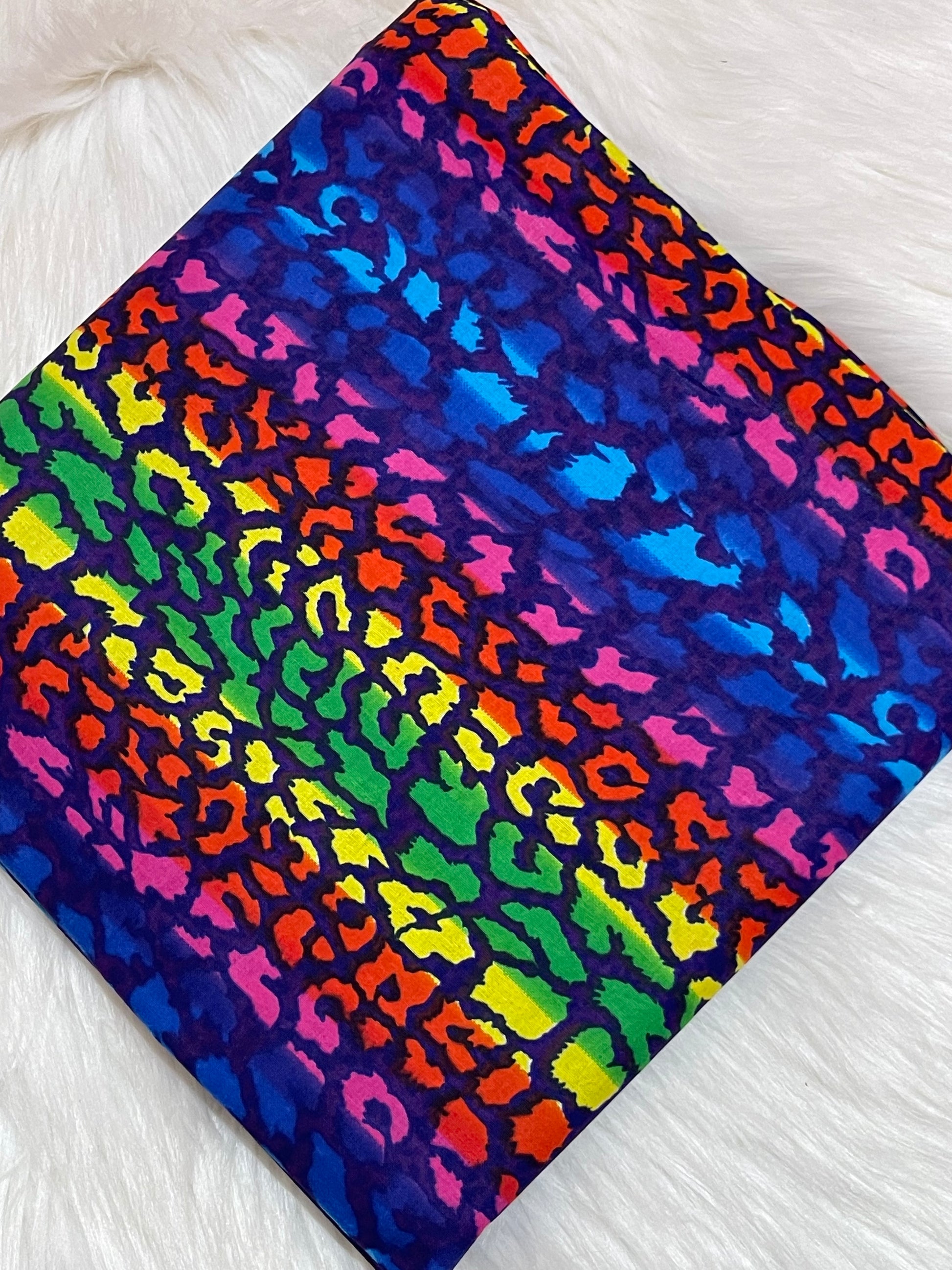 Colorful leopard print fabric on a white background