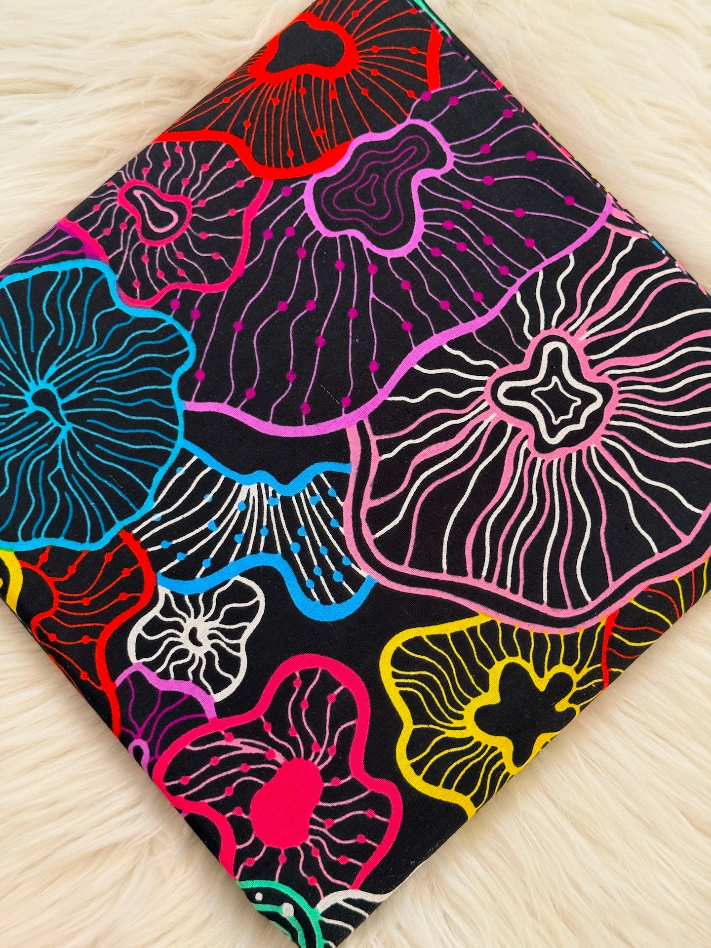 Colorful floral patterned fabric on a wooden surface