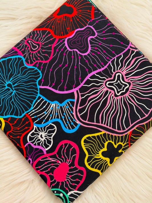 Colorful floral patterned fabric on a wooden surface