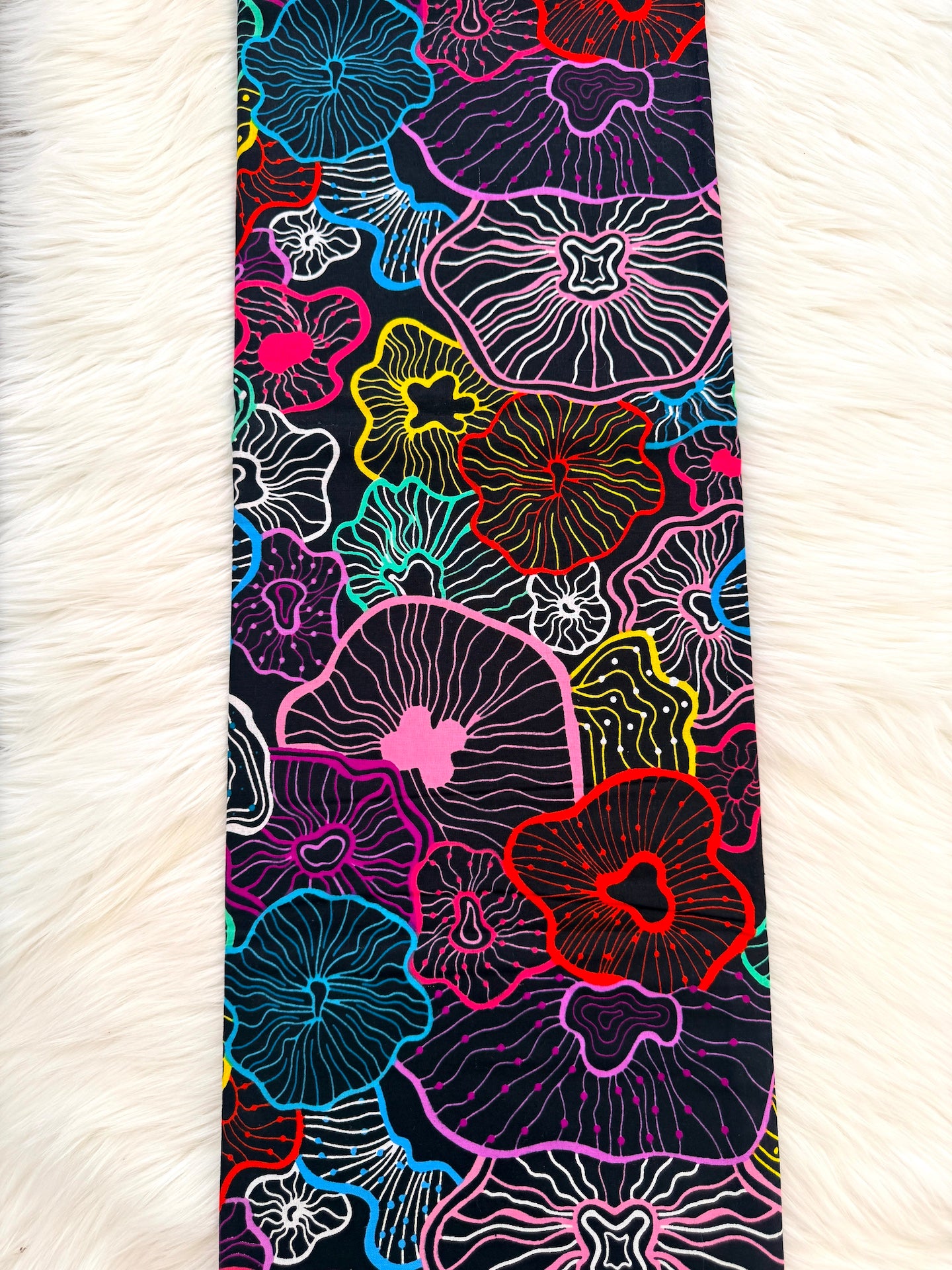 Colorful floral patterned tie on a white fur background