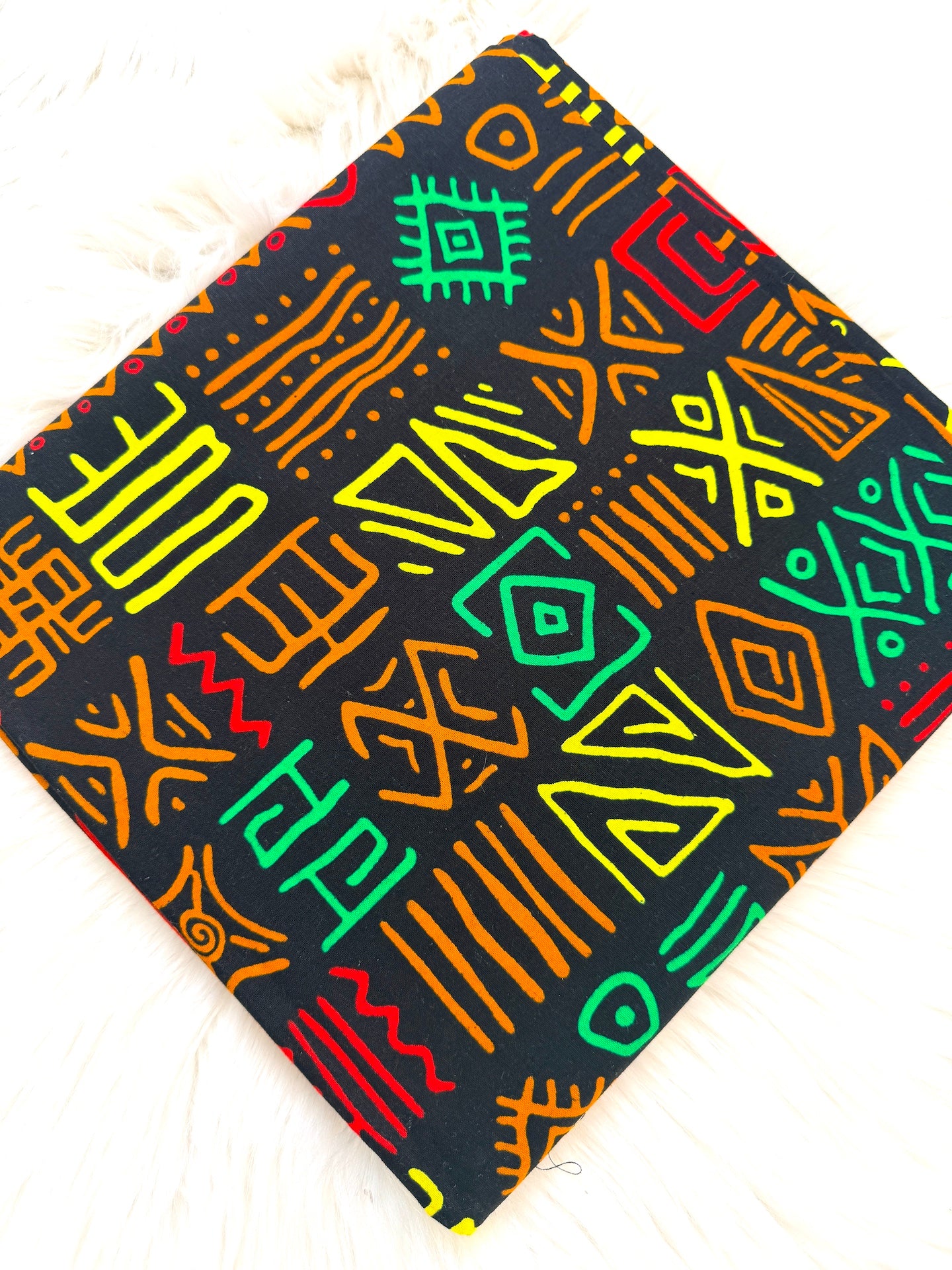Colorful geometric patterned fabric on a black background
