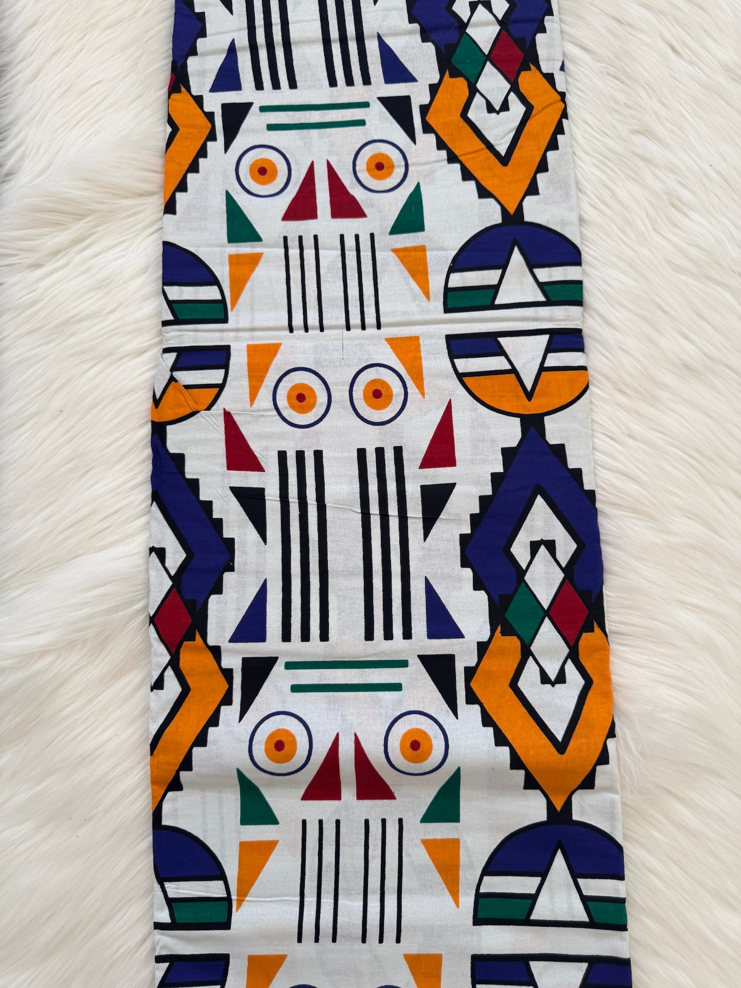 Colorful geometric patterned fabric with robot design on a white background