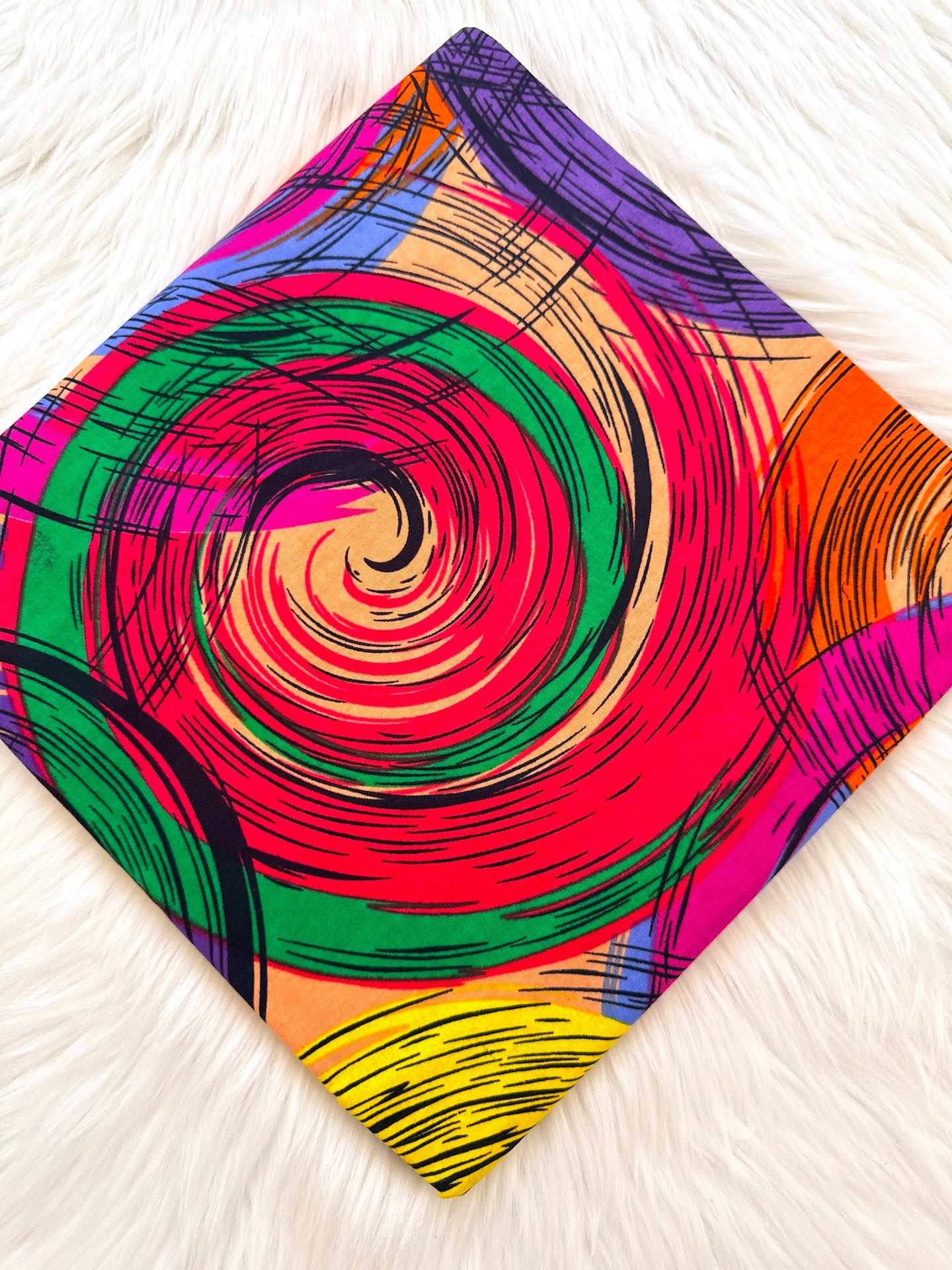 Colorful spiral patterned fabric on a white surface