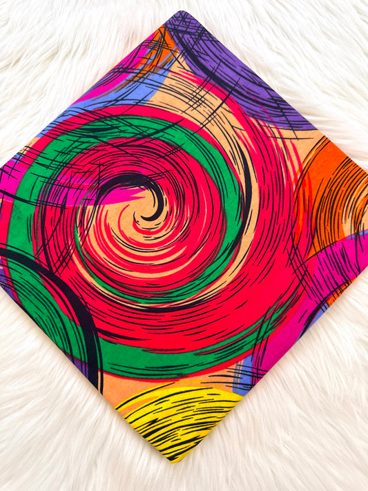 Colorful spiral patterned fabric on a white surface