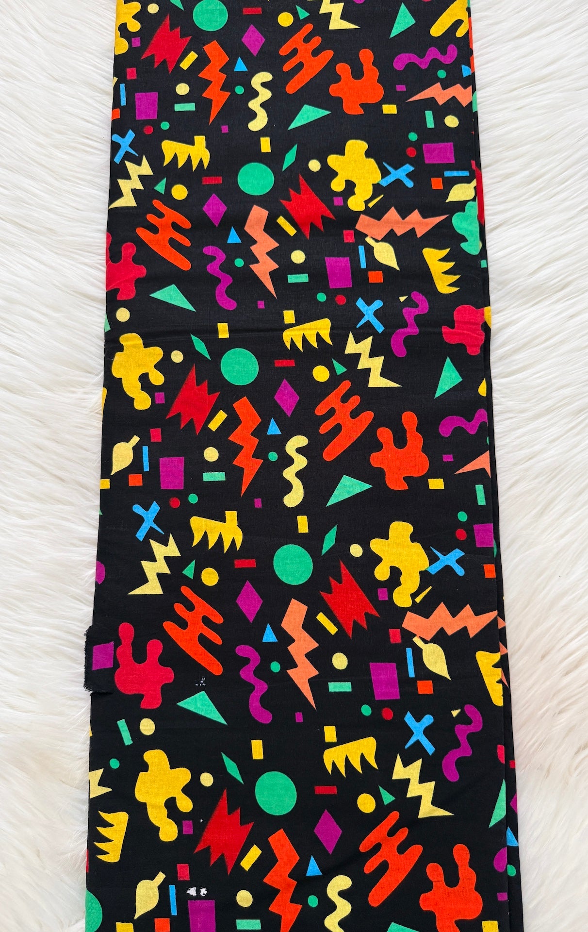 Colorful geometric patterned tie on a black background