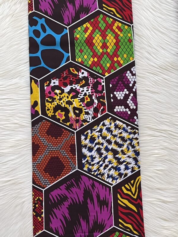 Colorful patterned tie with geometric designs on a white fur background