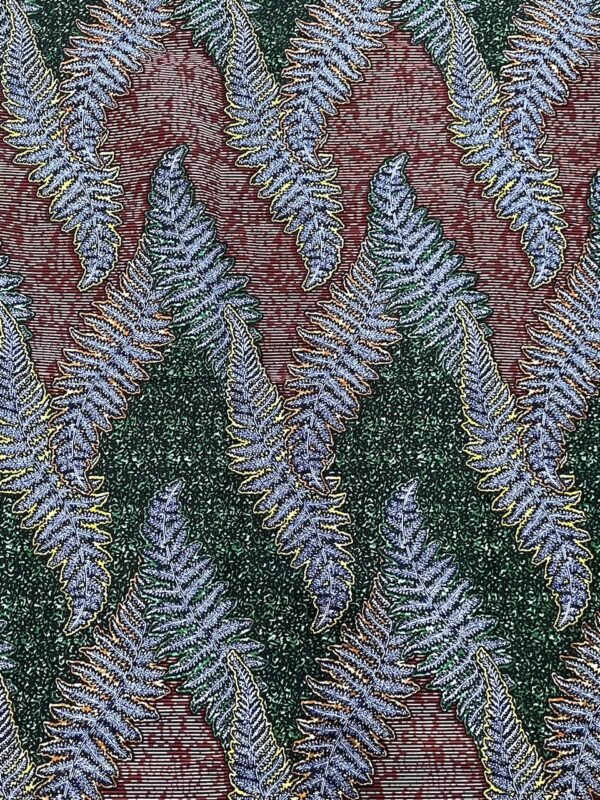Patterned fabric with fern leaves on a red and green background