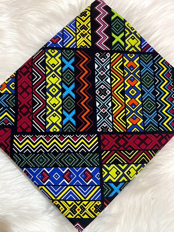 Colorful geometric patterned fabric on a white fluffy surface