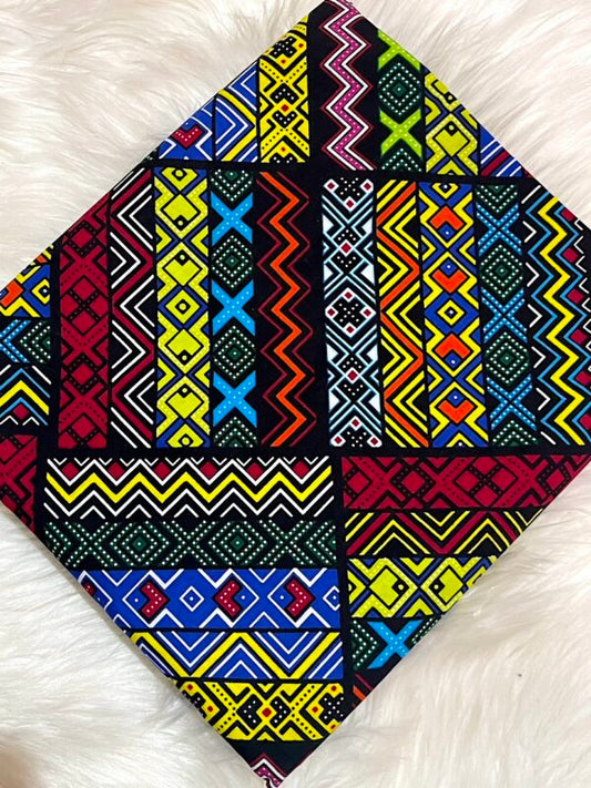 Colorful geometric patterned fabric on a white fluffy surface