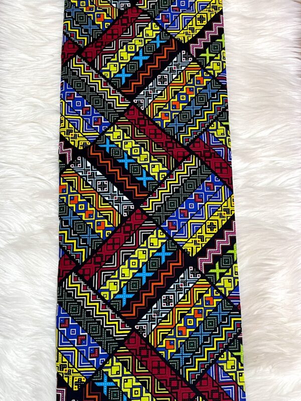 Colorful geometric patterned fabric on a white fur background