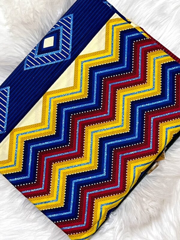 Colorful zigzag patterned fabric on a white fluffy surface