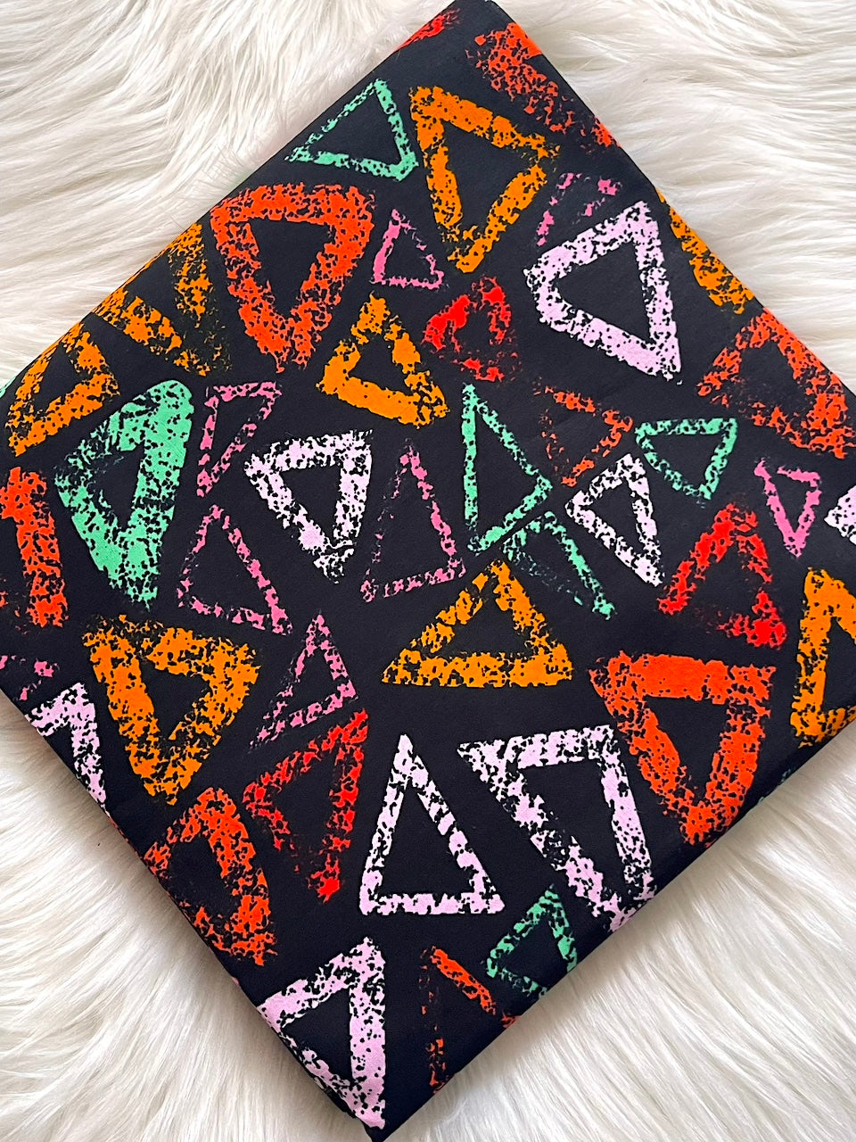 Colorful triangle pattern on a black background