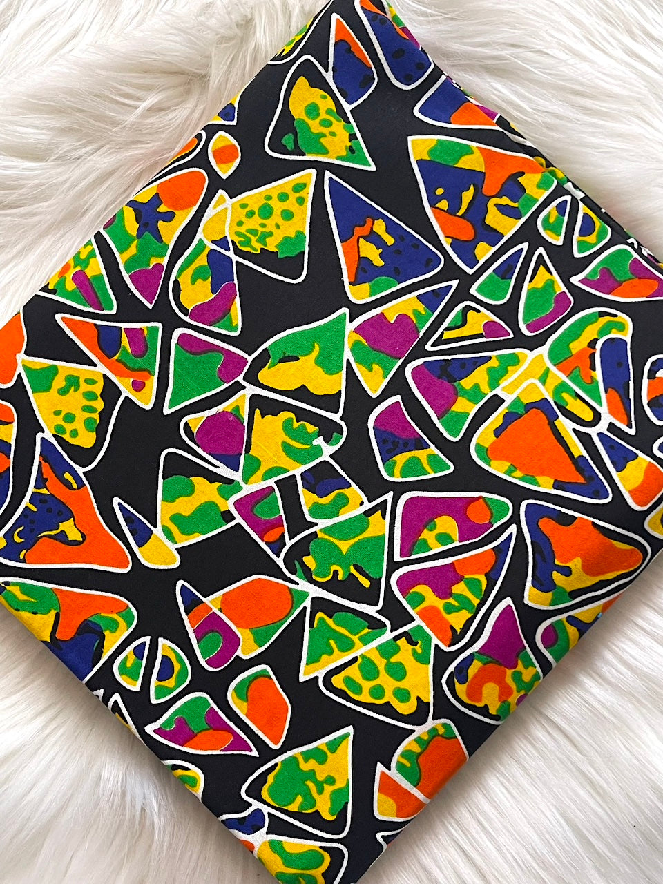 Colorful geometric patterned fabric on a white surface