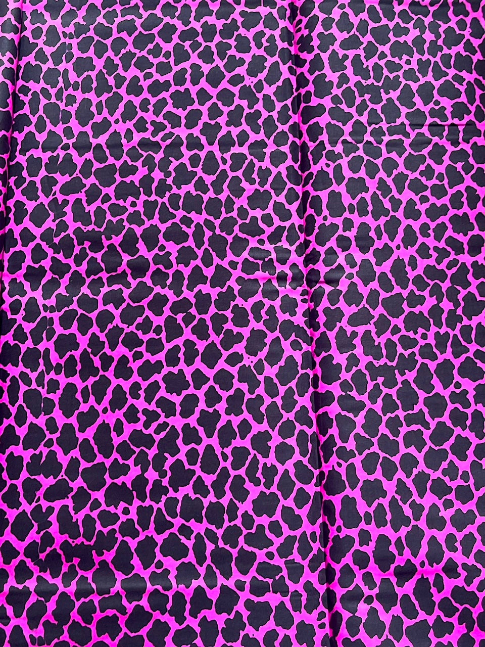 Pink fabric with black leopard print pattern