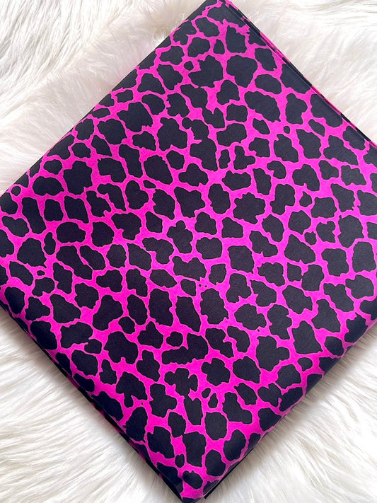 Pink and black leopard print fabric on a white background