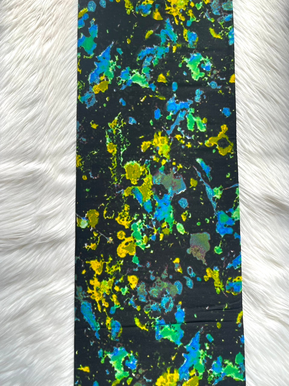 Colorful abstract pattern on a black background with white fur texture
