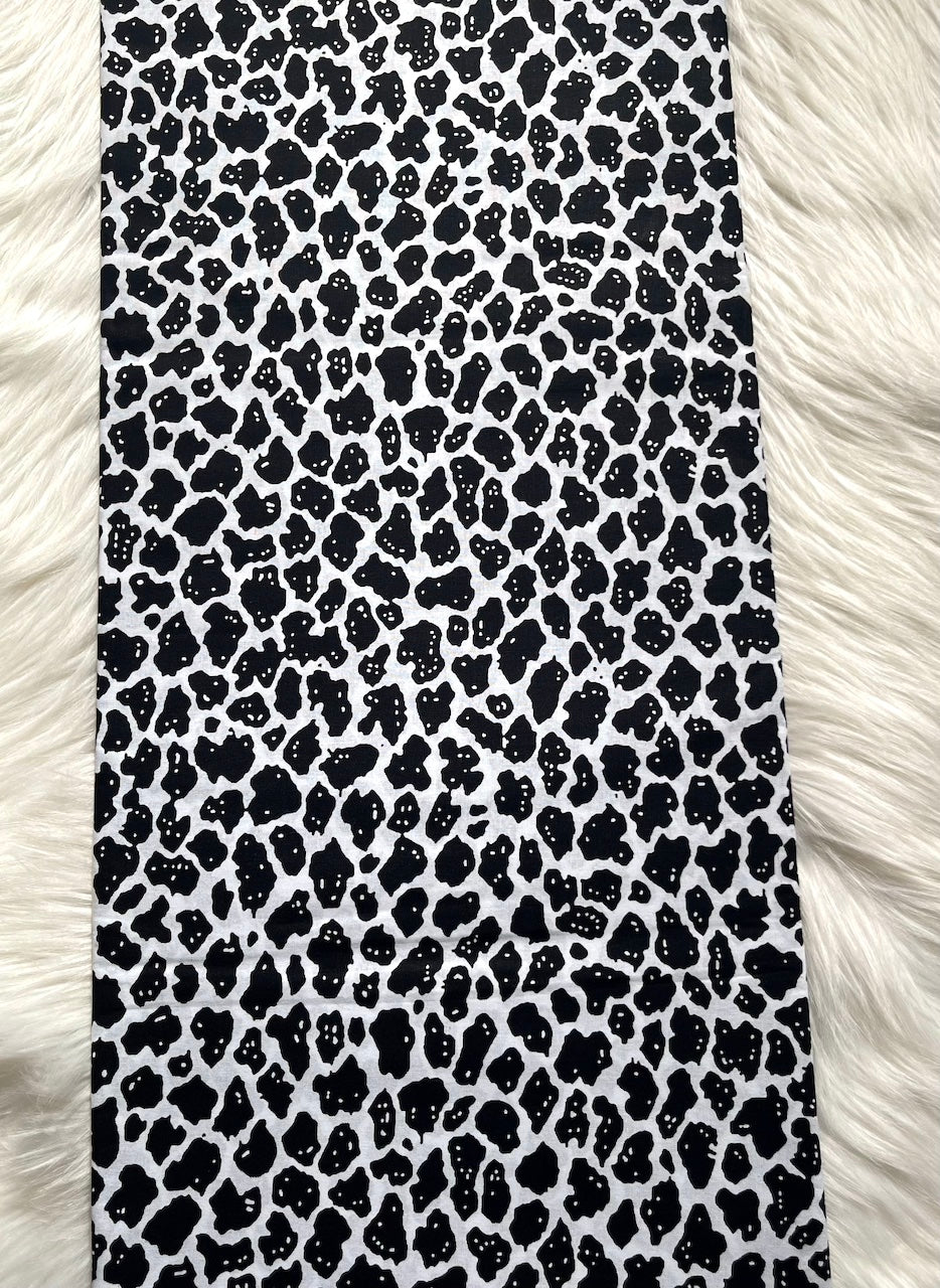 Phone case with black leopard print pattern on a white fur background