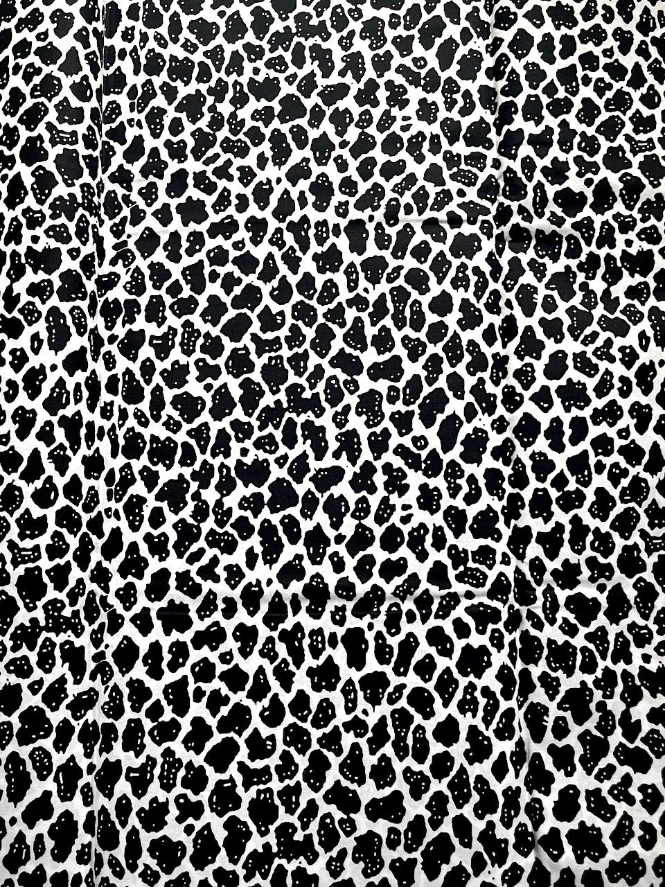 Black leopard print pattern on a white background