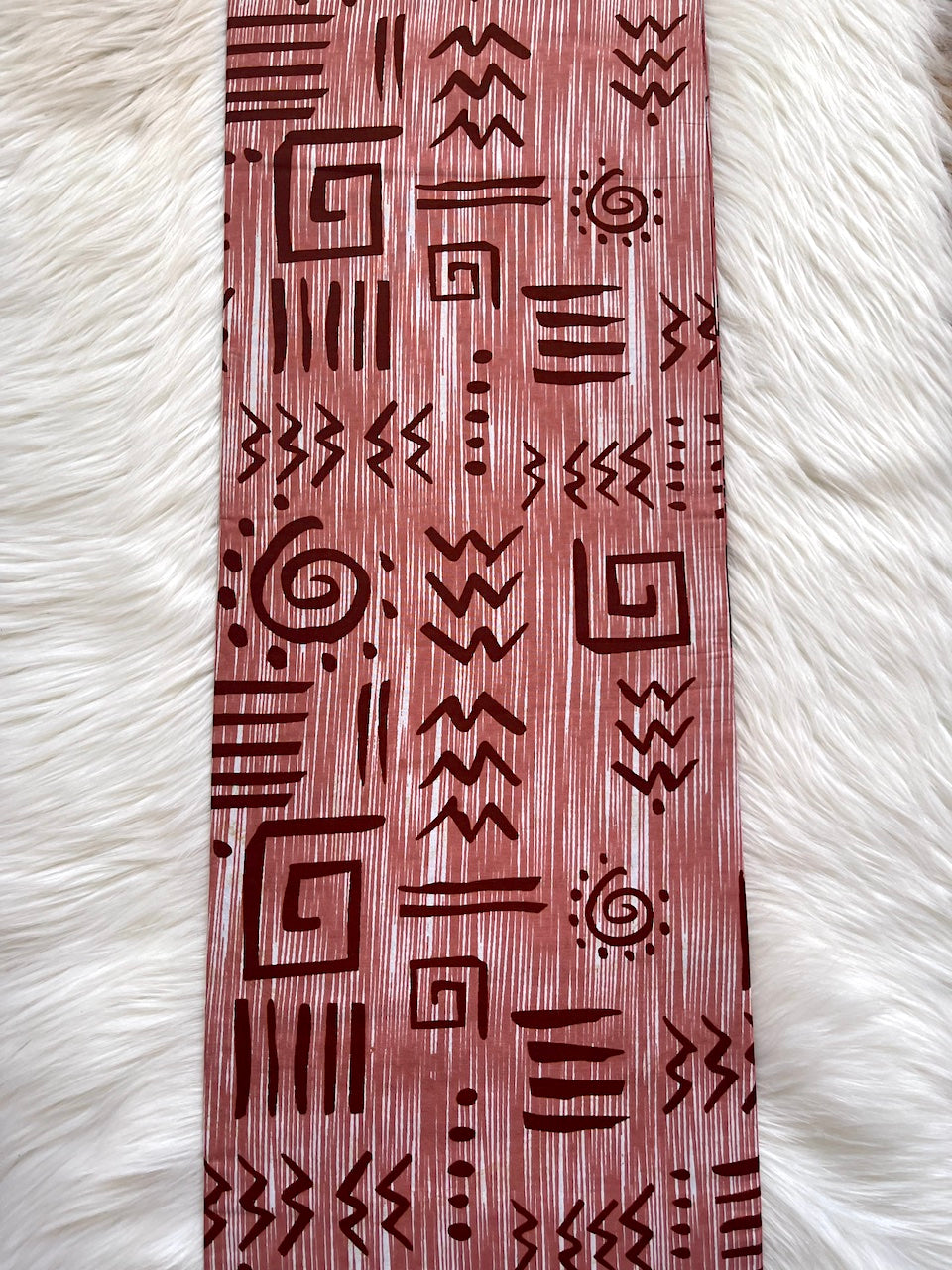 Wooden bookmark with tribal patterns on a white fur background
