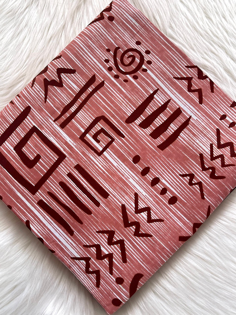 Card with tribal pattern on a textured white surface