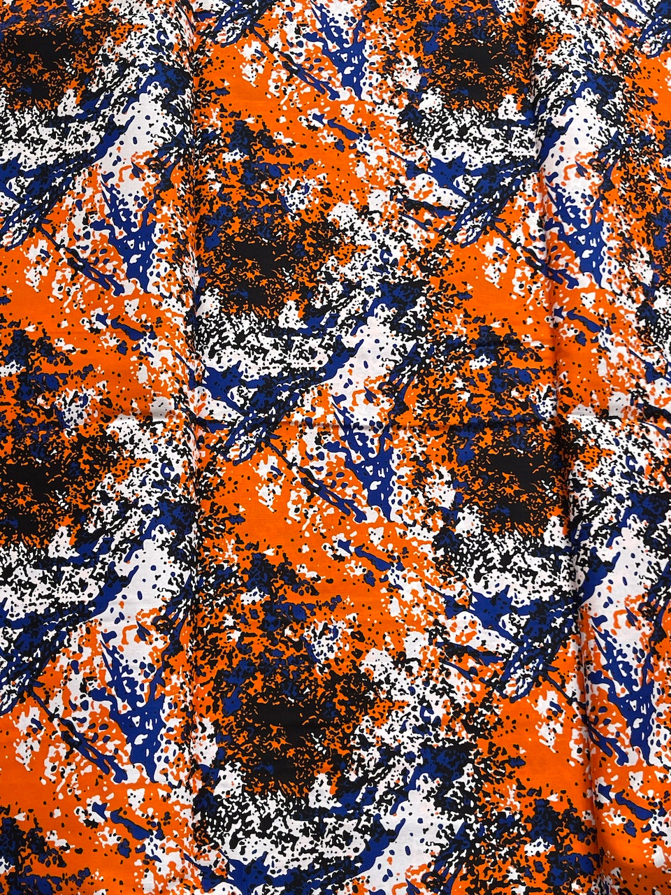 Abstract pattern with orange, blue, and white colors on a textured background