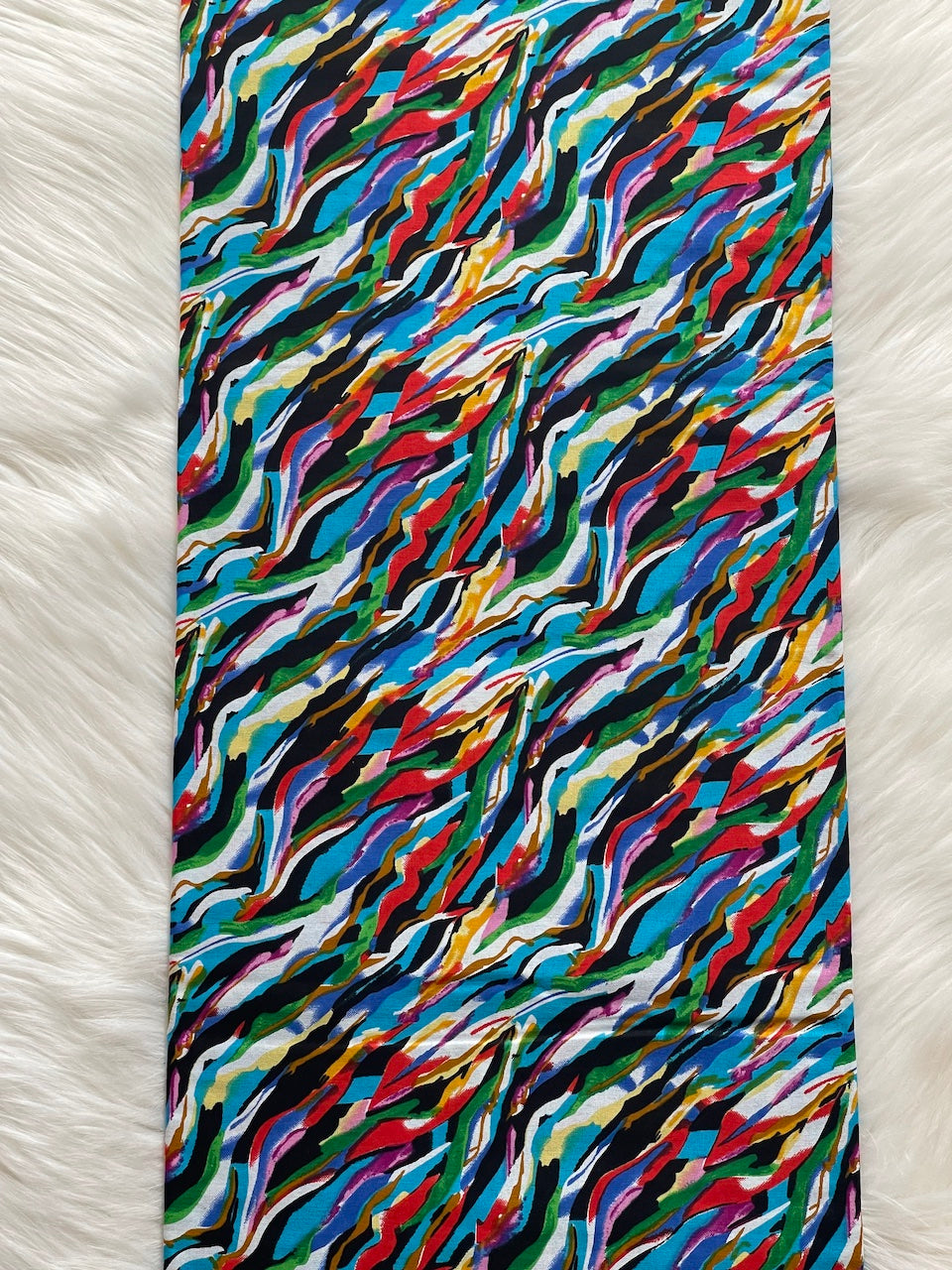 Colorful abstract patterned fabric on a white background