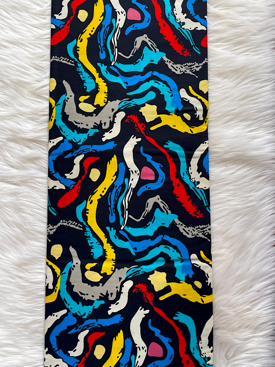 Colorful abstract patterned tie on a white fur background