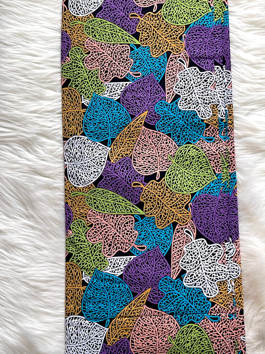 Colorful leaf patterned phone case on a white fluffy surface