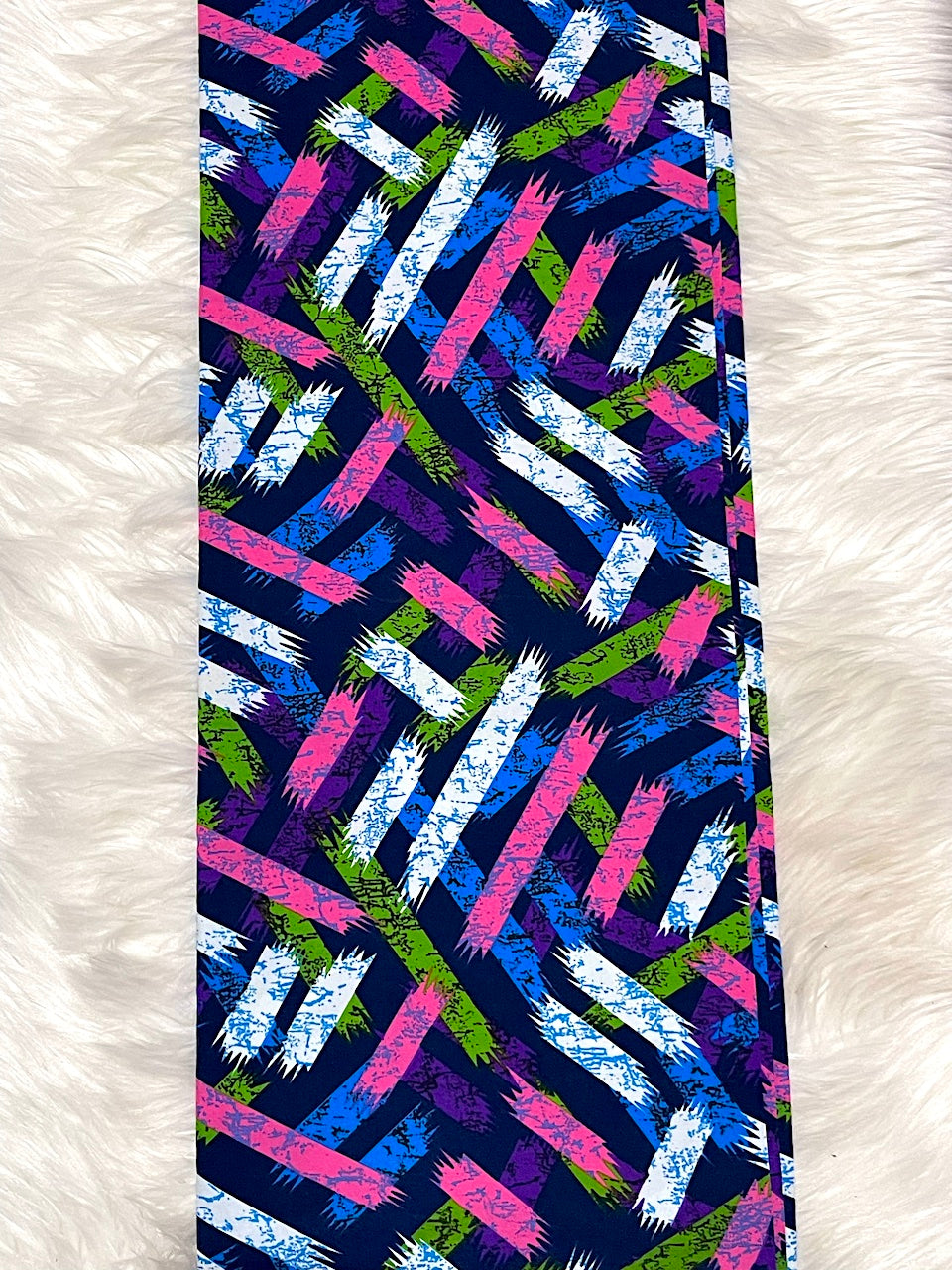 Colorful patterned fabric on a white fur background
