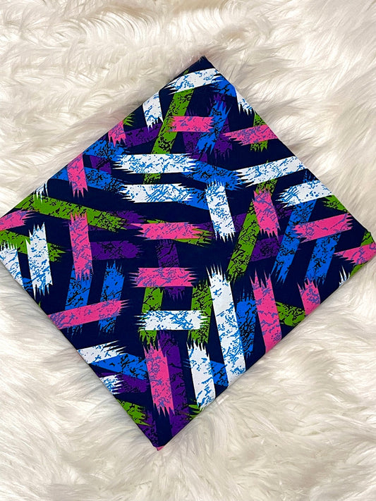 Colorful patterned fabric on a white fluffy surface