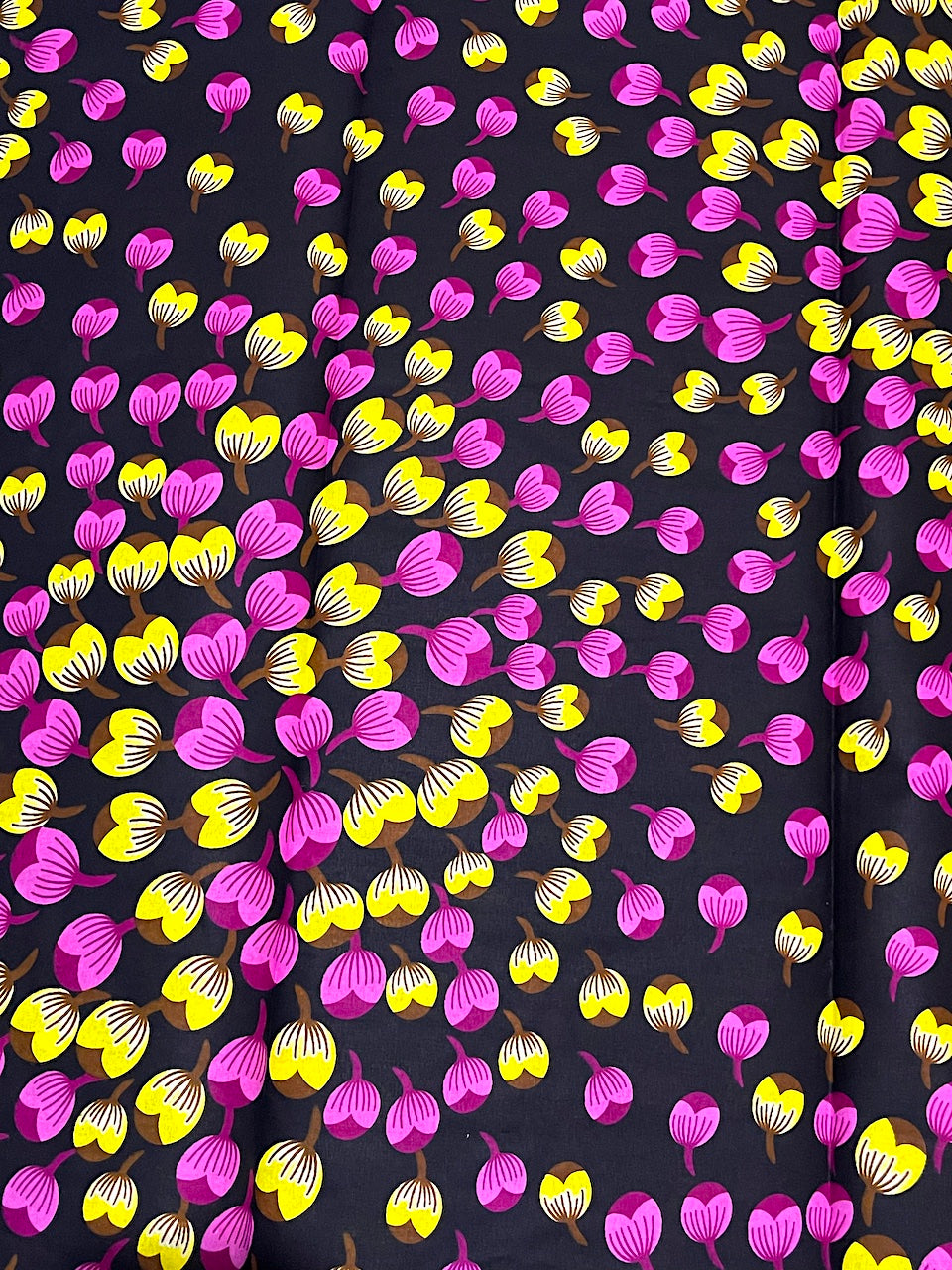 Pattern of pink and yellow hearts on a black background