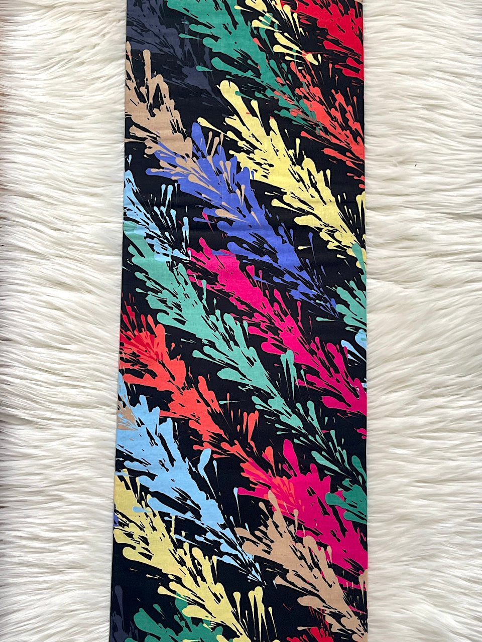 Colorful abstract patterned tie on a white textured background