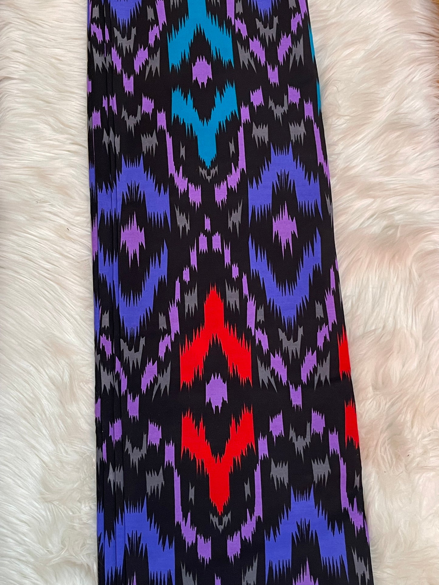 Colorful patterned fabric on a white fur background