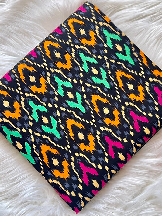 Colorful patterned fabric on a white textured surface