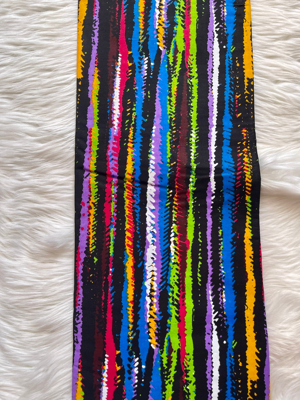 Colorful striped fabric on a white textured background
