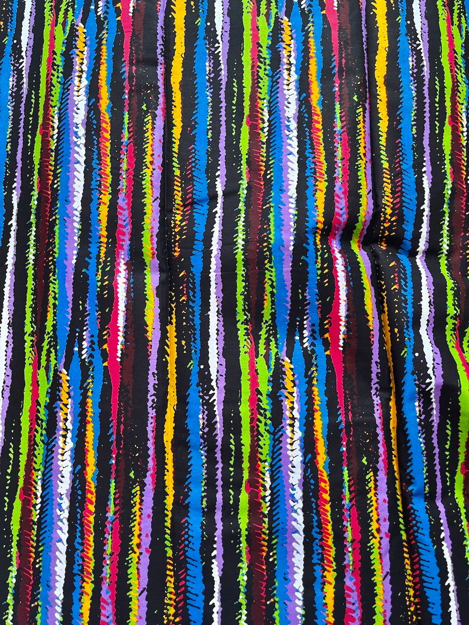Multicolored striped fabric pattern on a black background