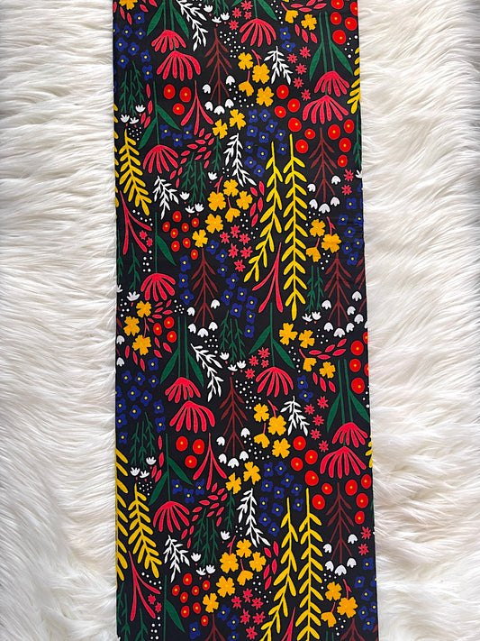 Colorful floral patterned fabric on a white fluffy surface